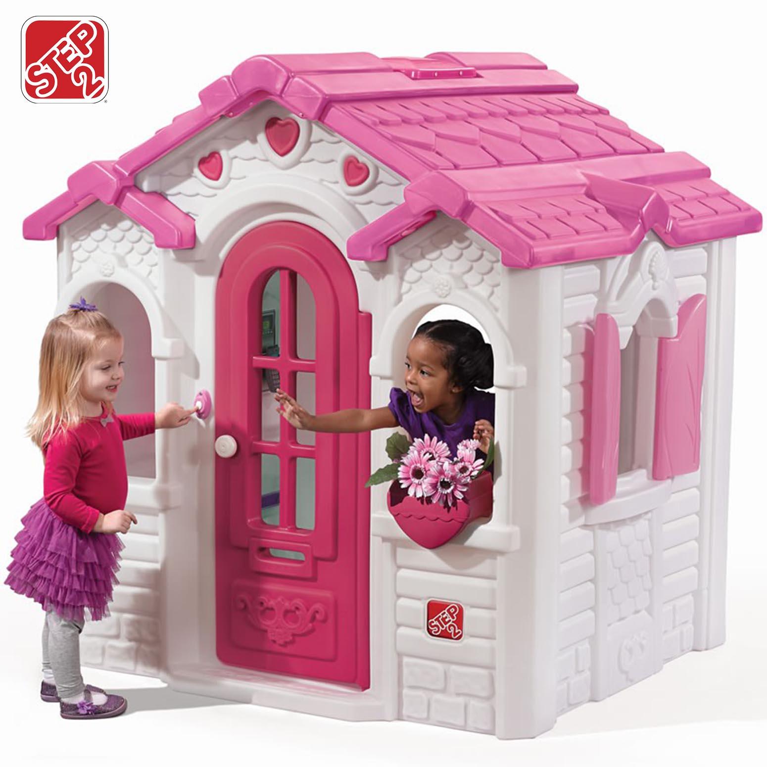 Little girl outside playhouse deals